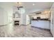 Open-concept living area showcasing fireplace, wood tile floors and eat in kitchen bar at 263 Baring Cross St, Henderson, NV 89074