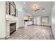 Elegant living room featuring a fireplace, wood tile flooring and a view into kitchen at 263 Baring Cross St, Henderson, NV 89074
