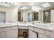 Bathroom showcasing dual sinks, white countertops, and stylish vanity mirrors at 2729 Echo Mesa Dr, Las Vegas, NV 89134