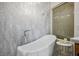 Stylish bathroom with a freestanding tub, marble accent wall, and an elegant faucet at 2729 Echo Mesa Dr, Las Vegas, NV 89134