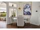 Bright dining area with a round glass table, stylish chairs, and modern starburst chandelier at 2729 Echo Mesa Dr, Las Vegas, NV 89134