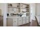 Elegant dining room with custom built-in cabinet, mirrored backsplash, and wood floors at 2729 Echo Mesa Dr, Las Vegas, NV 89134