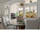 Open-concept dining room with modern light fixture and seating for four at 2729 Echo Mesa Dr, Las Vegas, NV 89134