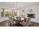 Dining room with wood floors, modern chandelier and a view of the golf course at 2729 Echo Mesa Dr, Las Vegas, NV 89134
