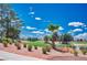Scenic golf course view with mature trees and blue sky, perfect for outdoor enthusiasts at 2729 Echo Mesa Dr, Las Vegas, NV 89134