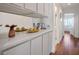 Bright hallway featuring hardwood floors, cabinetry, and a bathroom view at 2729 Echo Mesa Dr, Las Vegas, NV 89134