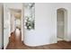 Hallway featuring hardwood floors, recessed lighting, and decorative floral arrangement in a display case at 2729 Echo Mesa Dr, Las Vegas, NV 89134
