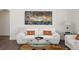 Cozy living room featuring a plush white sofa, glass coffee table, and colorful artwork at 2729 Echo Mesa Dr, Las Vegas, NV 89134