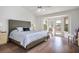Serene main bedroom with a comfortable bed, ceiling fan, and views of the outdoors at 2729 Echo Mesa Dr, Las Vegas, NV 89134