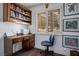 Home office featuring hardwood floors, a built-in bookcase, and natural light at 2729 Echo Mesa Dr, Las Vegas, NV 89134