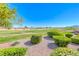 Well-maintained landscaping surrounds a lush green golf course view in backyard at 2734 Grand Forks Rd, Henderson, NV 89052