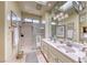 Bathroom featuring a shower with a glass door, double sinks, and a vanity at 2734 Grand Forks Rd, Henderson, NV 89052
