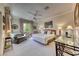 Spacious bedroom including a ceiling fan, seating, and an abundance of natural light at 2734 Grand Forks Rd, Henderson, NV 89052
