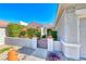 Well-maintained home featuring manicured shrubs and a gated front patio with a colorful seating area at 2734 Grand Forks Rd, Henderson, NV 89052