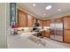 Bright kitchen with stainless appliances, white countertops, and custom wood cabinets at 2734 Grand Forks Rd, Henderson, NV 89052
