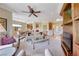 Spacious living room with a ceiling fan, neutral decor, and seamless transition to dining area at 2734 Grand Forks Rd, Henderson, NV 89052