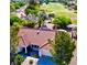 Aerial view of a charming home featuring a red tile roof, manicured landscaping, and a private driveway at 2920 Crown Ridge Dr, Las Vegas, NV 89134