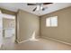 Neutral bedroom with ceiling fan, tile floors, a window and access to bathroom at 2920 Crown Ridge Dr, Las Vegas, NV 89134