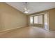 Neutral bedroom with ceiling fan, tile floors and large picture windows at 2920 Crown Ridge Dr, Las Vegas, NV 89134