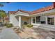 Inviting front porch with tiled entryway, mature landscaping, and a white stucco pillar at 2920 Crown Ridge Dr, Las Vegas, NV 89134