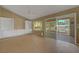 Bright living room with built-in cabinets, tile floors, and glass sliding doors leading to the backyard at 2920 Crown Ridge Dr, Las Vegas, NV 89134