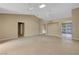 Large living room with tile floors, a vaulted ceiling, neutral paint, and built-in shelving and cabinetry at 2920 Crown Ridge Dr, Las Vegas, NV 89134