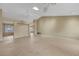 Spacious living room with high ceilings, neutral walls, tile floors, ceiling fans, and abundant natural light at 2920 Crown Ridge Dr, Las Vegas, NV 89134