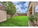 Enjoy this spacious backyard with lush artificial turf, privacy wall, and desert landscaping at 306 Saint Augustine Ln, Henderson, NV 89014