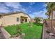 Relax in this backyard featuring low-maintenance artificial turf and desert landscaping at 306 Saint Augustine Ln, Henderson, NV 89014