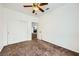 This bedroom features a ceiling fan, an open door, and a spacious closet with sliding doors at 306 Saint Augustine Ln, Henderson, NV 89014