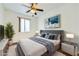 A bedroom featuring a bed, ceiling fan, and modern decor and a plush rug at 306 Saint Augustine Ln, Henderson, NV 89014