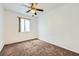 This bedroom is a blank canvas with carpet, a ceiling fan, and natural light at 306 Saint Augustine Ln, Henderson, NV 89014