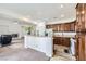 Open kitchen with granite countertops, wood cabinets, and seamless flow to the living area at 306 Saint Augustine Ln, Henderson, NV 89014