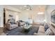 Inviting living room featuring plush seating, a ceiling fan, and bright, neutral decor at 306 Saint Augustine Ln, Henderson, NV 89014
