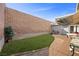 Private backyard offers artificial grass, block wall, and covered patio area for outdoor dining at 3323 Maclyon Way, Las Vegas, NV 89121