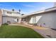 Spacious backyard with low-maintenance turf, brick patio, and an outdoor dining area, perfect for entertaining at 3323 Maclyon Way, Las Vegas, NV 89121