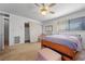 Bedroom with a ceiling fan, large window, and comfortable furnishings, creating a relaxing space at 3323 Maclyon Way, Las Vegas, NV 89121