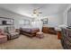 Cozy bedroom featuring neutral carpet, ceiling fan, and comfortable furnishings at 3323 Maclyon Way, Las Vegas, NV 89121
