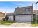 Well-maintained home with lush green lawn, mature landscaping, and attached two-car garage at 3323 Maclyon Way, Las Vegas, NV 89121