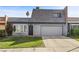 Charming two-story home featuring a two-car garage and well-maintained front yard with lush green grass at 3323 Maclyon Way, Las Vegas, NV 89121