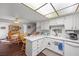 Bright kitchen featuring white cabinetry, modern appliances, bar-top seating, and ample counter space at 3323 Maclyon Way, Las Vegas, NV 89121
