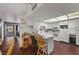 Modern kitchen with white cabinets, appliances, breakfast bar, with views to the living room at 3323 Maclyon Way, Las Vegas, NV 89121