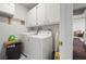 Functional laundry room with washer, dryer, and ample storage space at 3323 Maclyon Way, Las Vegas, NV 89121