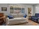 Relaxing living room with comfortable sofa, cozy decor, and view to the backyard at 3323 Maclyon Way, Las Vegas, NV 89121