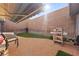 Enclosed patio features tile flooring, artificial grass, a grill, and retractable sun shade for privacy at 3323 Maclyon Way, Las Vegas, NV 89121