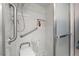 Modern tiled shower with glass door, grab bars, and built-in niche at 3323 Maclyon Way, Las Vegas, NV 89121