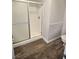 Modern bathroom features a walk-in shower with a sliding glass door, safety bars, and neutral colors at 3619 Edinburgh Dr, Las Vegas, NV 89103