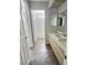 Bathroom featuring linoleum flooring, light colored cabinets, and a doorway to the toilet and shower at 3619 Edinburgh Dr, Las Vegas, NV 89103