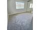 Relaxing bedroom with neutral carpet and walls and a large window at 3619 Edinburgh Dr, Las Vegas, NV 89103