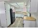 Cozy kitchen with white appliances, cabinets, light countertops and wood floors at 3619 Edinburgh Dr, Las Vegas, NV 89103